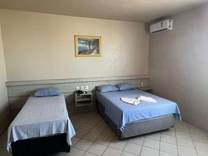 a hospital room with two beds in a room at Hotel Central in Porto Velho