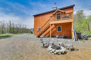 a group of chairs sitting in front of a building at Fire Pit and Beach Access Quiet Northville Retreat in Benson