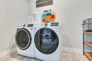 a washer and dryer in a laundry room at Fire Pit and Beach Access Quiet Northville Retreat in Benson
