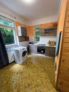 a kitchen with a washing machine and a microwave at Monteurwohnung - Worker's apartment - Pforzheim Belremstraße in Pforzheim