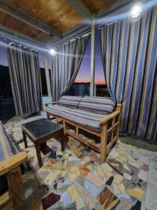 a room with a bed and a table and a window at Alaa Aldin Flats in Luxor