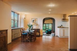 a kitchen and living room with a table and chairs at Apartments Florence - Villa La Medicea with swimming pool in Montauto