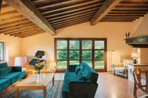 a living room with blue couches and a table at Apartments Florence - Villa La Medicea with swimming pool in Montauto