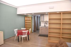 a kitchen and dining room with a table and chairs at Loft Atenea in Agrigento