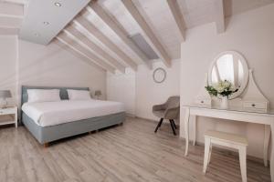 a bedroom with a bed and a desk and a mirror at Corfu Town Luxury Studios -A in Corfu Town