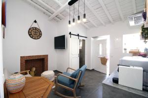 a living room with a table and a fireplace at Refúgio do Alqueva in São Marcos do Campo