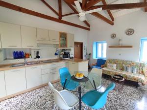 a kitchen and living room with a table and chairs at Green Olive House in Agios Nikolaos