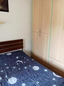 a bedroom with a bed with a blue blanket with stars at Camere ANNA in Florence