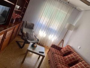 a living room with a couch and a chair at Apartamento Torrelavega in Torrelavega