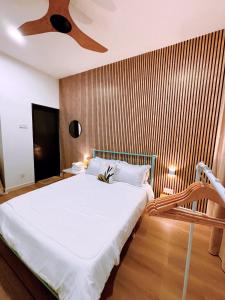 una camera da letto con un grande letto bianco e un soffitto di Muji Homestay Ria Heights Tawau a Tawau