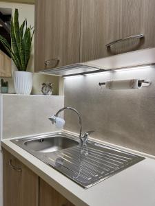 - un évier de cuisine avec un robinet sur un comptoir dans l'établissement Loft32Pavia, moderno appartamento di 60mq in zona stazione, à Pavia