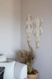 a living room with a white couch and chandeliers at Koukounaraki Apartment 1 in Skiathos