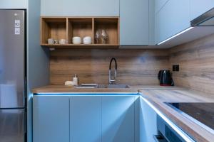 a kitchen with a sink and a refrigerator at Koukounaraki Apartment 1 in Skiathos