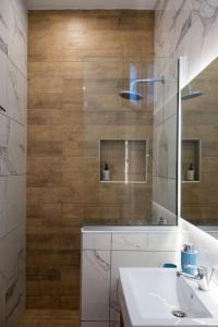 a bathroom with a sink and a mirror at Koukounaraki Apartment 1 in Skiathos