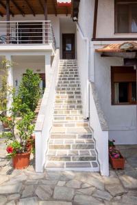 a staircase leading up to a building with plants at Koukounaraki Apartment 1 in Skiathos