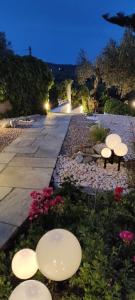 a row of white lights in a garden at night at Koukounaraki Apartment 1 in Skiathos