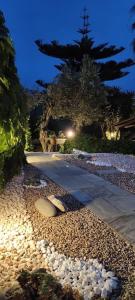 a walkway with rocks on the ground at night at Koukounaraki Apartment 1 in Skiathos