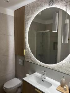 a bathroom with a sink and a mirror at Pokoje gościnne u Doroty in Kazimierz Dolny