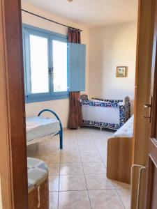 a room with two beds and a window at 2 bedrooms apartement at Lotzorai 800 m away from the beach with furnished balcony in Lotzorai