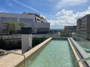 a swimming pool on the roof of a building at Apartamentos Luna Suites Granada in Granada