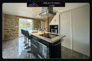 a kitchen with a island with a counter top at Aux portes de la baie - Vieux-Viel in Vieux-Viel