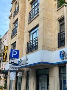 a building with a parking sign in front of it at Гостиница Низами Стрит in Baku