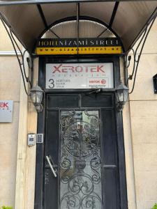 a door on a building with a sign above it at Гостиница Низами Стрит in Baku