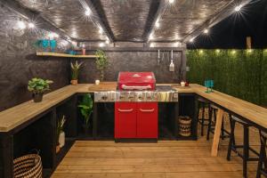 a kitchen with a red stove top on a deck at The Lodge at The Outside Inn in Mountfield