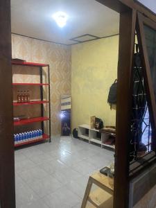 Aqilun Coffe home في Seturan: غرفة مع غرفة مع رف من زجاجات النبيذ