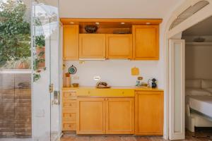 a kitchen with wooden cabinets and a sink at 23Baci, Capri in Capri +28 photos