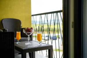 a table with two glasses of orange juice on a balcony at Imperial rooms in Mostar