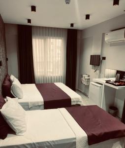 a hotel room with two beds and a kitchen at Alanya My Boutique Hotel in Alanya
