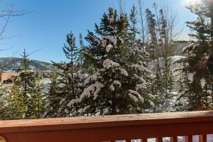 a christmas tree covered in snow on a deck at Lagoon 723D by Great Western Lodging in Frisco