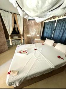 Ένα ή περισσότερα κρεβάτια σε δωμάτιο στο VioLet House Watamu