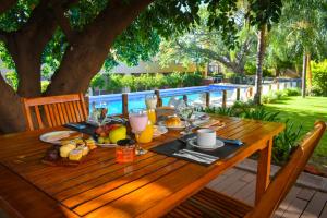 - une table en bois avec de la nourriture et des boissons dans l'établissement Hotel Casino Catamarca, à San Fernando del Valle de Catamarca