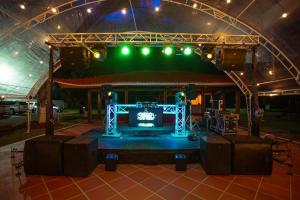 a stage with green lights and a stage set up at Finca El Descanso in Villavicencio