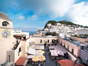 a view of a town with a clock on a hill at 23Baci, Capri in Capri