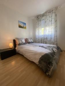 a bedroom with a large bed in a room at Au Clos Celestin in Annemasse