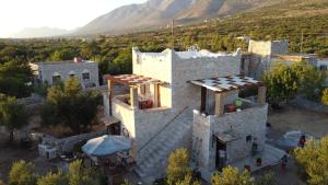 an aerial view of a building with mountains in the background at villa bilimots in Érimos