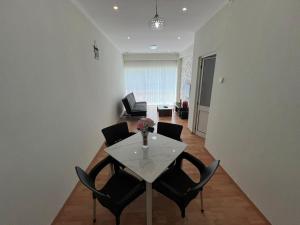 a living room with a white table and chairs at J´S Place in Lubango