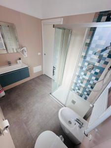 a bathroom with a shower and a toilet and a sink at B&B Raphaël in Marigliano +12 photos