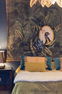a bedroom with a tapestry on the wall at Coco Lagon accès plage in Saint-Paul