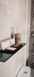 a shelf in a bathroom with a toilet and a book at Casa Rural El Abuelo Anselmo in Segovia +126 photos
