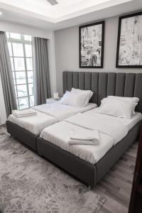 a bedroom with two beds with white sheets at Hiyala home in Male City