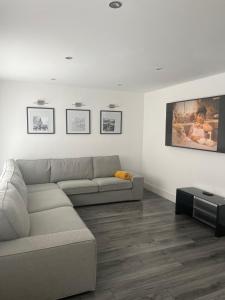 a living room with a couch and a tv at No 29 - Beautiful 4-Bed House in Liverpool