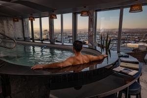 a man in a swimming pool at a hotel at Le Capitole Hotel in Quebec City