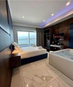 a bedroom with a large bed and a bath tub at Imperatrice Suites in Naples