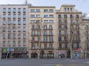 a large beige building on a city street at Ola Living Broto in Barcelona