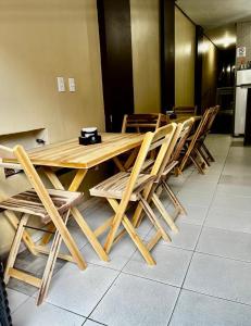 a group of wooden chairs around a wooden table at Hotel Santiago Juazeiro in Juazeiro do Norte