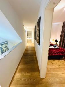 a hallway leading to a bedroom with a bed at LUXURY STAY SALZBURG City in Salzburg